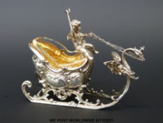 A continental white metal troika salt with gilt wash interior and glass liner (length 10cm)