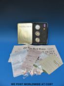 A commemorative silver proof coin collection comprising three £5 coins, three enamel badges,