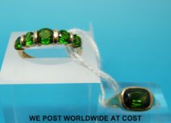 A 9ct gold ring set with five green stones and a 14ct gold ring set with a green stone