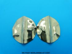 A pair of yellow metal earrings in a circular shape