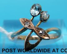 A Russian gold ring marked 56 set with an aquamarine and rose cut diamonds in a stylised foliate