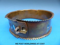 A heavy Victorian brass dog collar with five slot and loop adjustment, twist locking mechanism,