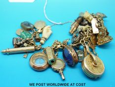 A 9ct gold charm bracelet set with a large number of charms, some Victorian including fobs, seals,