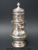 An Edward VII hallmarked silver sugar caster, with fluted lower body,