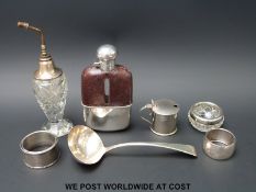 A Georgian hallmarked silver ladle, three silver napkin rings and a mustard, weight of silver 131g,