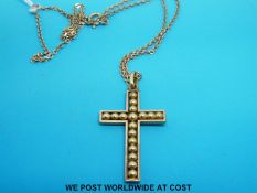A yellow metal cross on a 9ct gold chain (5.