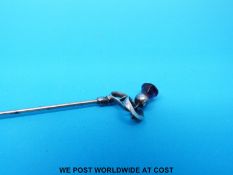 A hallmarked silver hatpin in the form of a thistle set with an amethyst to the top by Charles