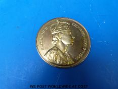 A cased 1953 yellow metal Spink Coronation medallion with sheet detailing original price of 9ct