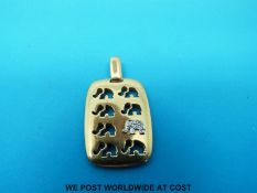 An 18ct gold C'est Laudier pendant with cut out design of elephants,
