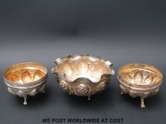 A pair of Indian or similar white metal bowls with gilt interiors together with a further larger