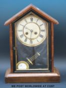 An American two train mantel clock with Roman numerals on painted dial and Brequet style hands,