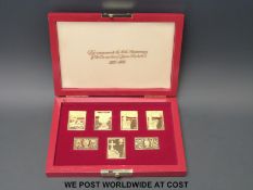 A cased set of seven silver gilt stamps approximately 140g in total