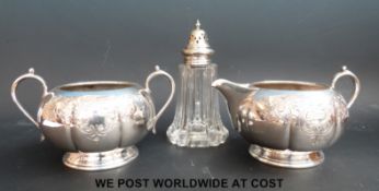 A silver plated milk jug and sugar bowl together with a sugar caster