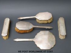A hallmarked silver five piece dressing table set