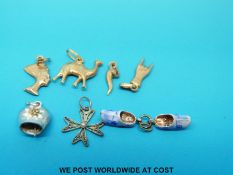 Four 18ct gold charms,