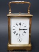 A French Gilt-brass Grande Sonnerie carriage clock with alarm, gorge case with oval top glass,
