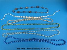 A mother of pearl beaded necklace, a graduated glass bead necklace, blue glass necklace,