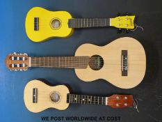A Yamaha 'Soprano' or child's acoustic guitar in soft case together with two ukuleles