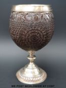 A George III hallmarked mounted carved coconut cup dated 1766 to carving,