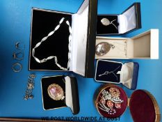 A collection of silver jewellery to include a locket, necklaces, necklaces, ring,