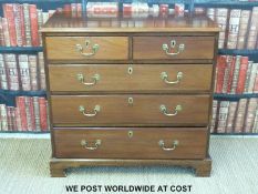 A Georgian mahogany chest of two over three graduated drawers raised on bracket feet (H92 x W97 x