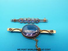 Two yellow metal brooches set with amethysts