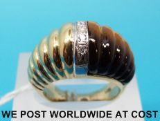 A yellow metal ring marked 14ct gold set with carved tigers eye and a row of diamonds (size K)