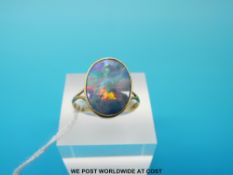 A yellow metal ring marked 18ct gold set with a doublet opal, (size P, 2.