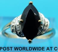 A 9ct gold ring set with a dark stone and diamonds (size O)