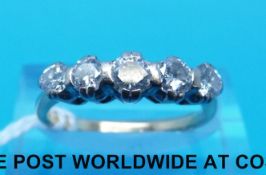 A yellow metal ring marked 18ct set with five round cut diamonds (size K)