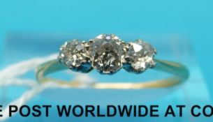 A yellow metal ring set with three diamonds in a platinum setting (size L)