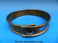 A Victorian brass dog collar with two slot and loop adjustments to take a padlock,