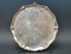 A Victorian hallmarked silver salver, the shaped edge having ram's head and shield design,