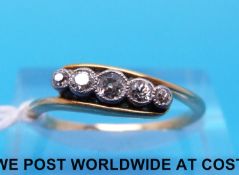 A yellow metal ring marked 18ct set with five graduated diamonds (size N)