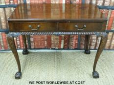 A mahogany two drawer side table raised on ball and claw feet (H71 x L89 x D48cm)