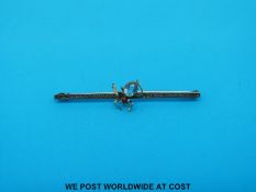 A yellow metal brooch in the form of a spider set with a ruby and aquamarine marked 9ct