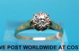 A yellow metal ring marked 18ct set with a round brilliant cut diamond in an illusion setting (size