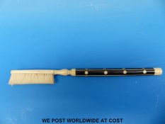 A 19thC inlaid bone, tooth or similar brush (overall length 17.