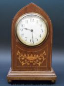 An inlaid Gothic style mantel clock in Mitre shaped case raised on brass ball feet