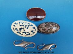 Two silver brooches, one set with carnelian agate the other moss agate,