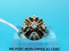 A yellow metal ring marked 14ct set with five diamonds and alternating black enamel sections (size