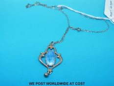 A hallmarked silver pendant by Charles Horner set with an oval section of blue enamel,