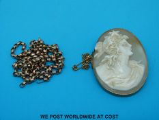 A yellow metal belcher chain marked 9ct and a yellow metal brooch set with a cameo