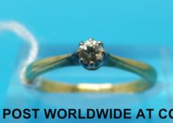 A yellow metal ring set with a solitaire diamond (size L)