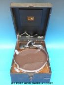 A vintage c1920 portable wind up gramophone in rexine finish