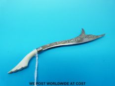 A white metal brooch in the form of a scimitar with an ivory handle