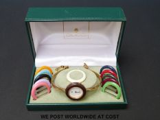 Gucci gold plated ladies wristwatch with 12 interchangeable bezels of various colours,