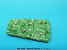 A carved jadeite brooch set with diamonds and rubies