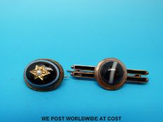 A yellow metal brooch set with an agate cabochon and another brooch with an oval cabochon set with