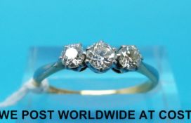 A yellow metal ring marked 18ct set with three diamonds (size O)